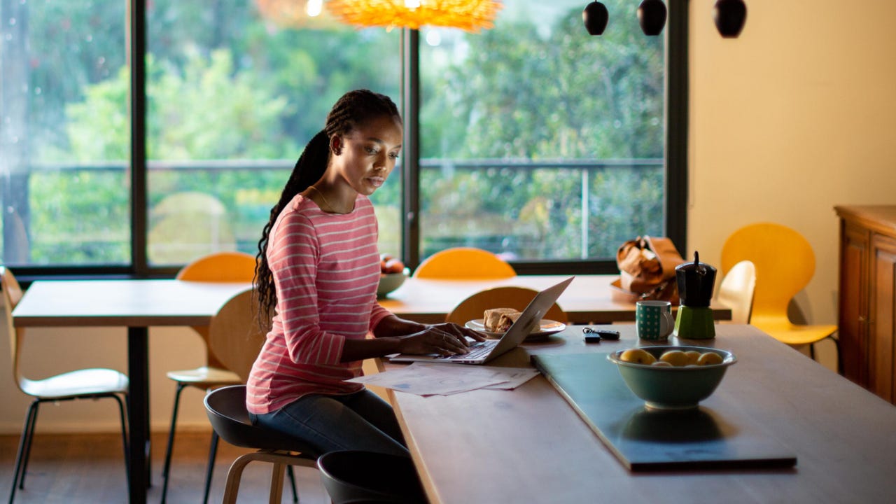 Woman working on her laptop at home