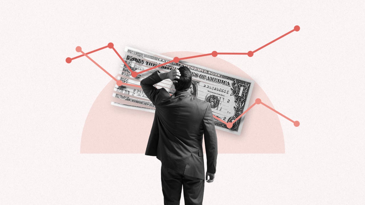 Image of the back of a man in a suit standing in front of a large line graph that is on top of a half shredded U.S. Dollar.