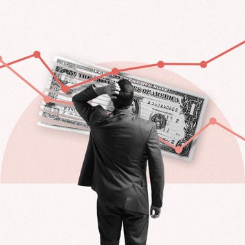 Image of the back of a man in a suit standing in front of a large line graph that is on top of a half shredded U.S. Dollar.