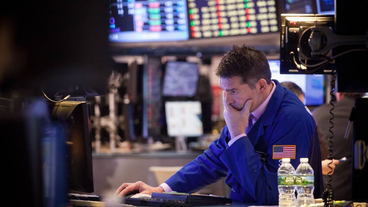 Trader looking at a screen on the floor of an exchange.