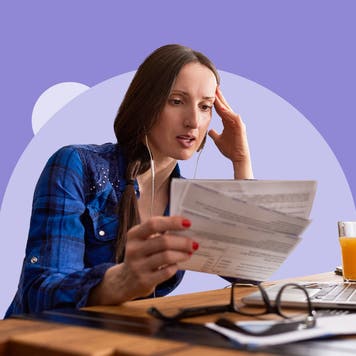 Person studying various checks, money