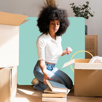A woman unpacking books