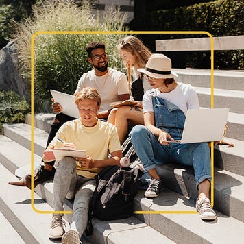Four college students sitting on outside stairs comparing notes and talking with a yellow illustrated border around them