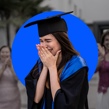 college graduate moved to tears as people clap in the background