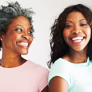 Black mother and daughter smiling happily