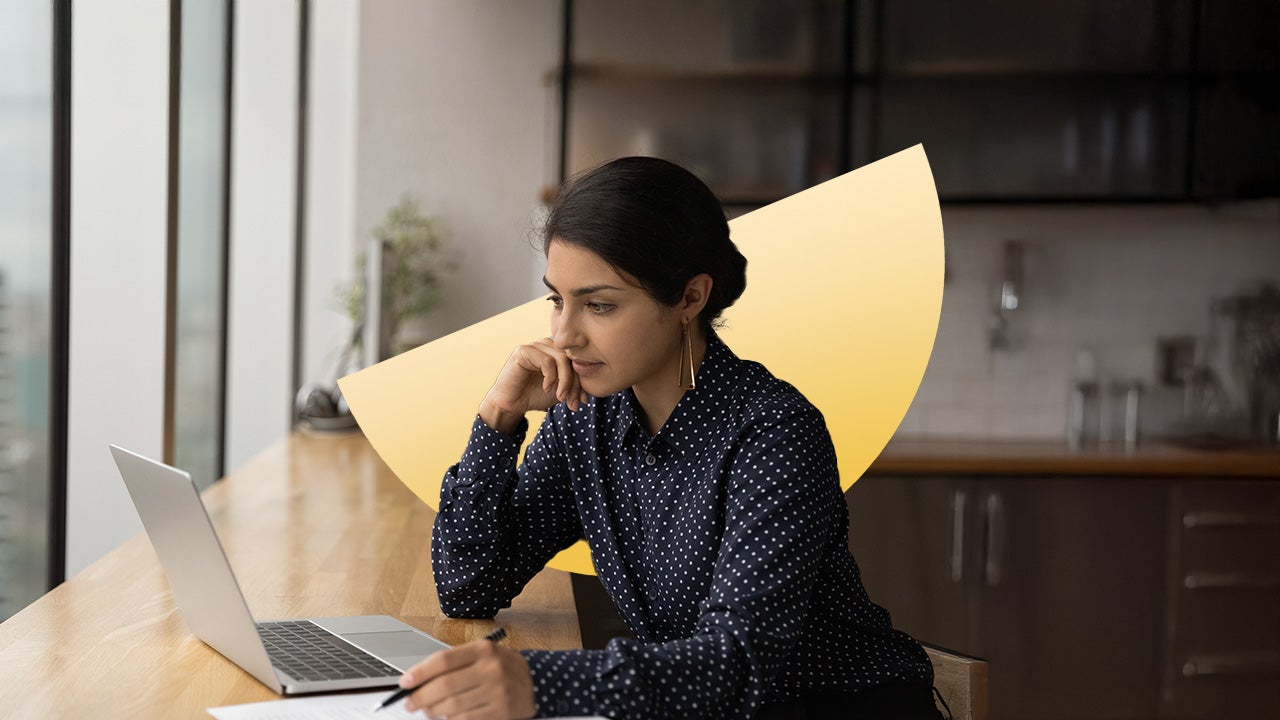 South Asian woman working on her laptop