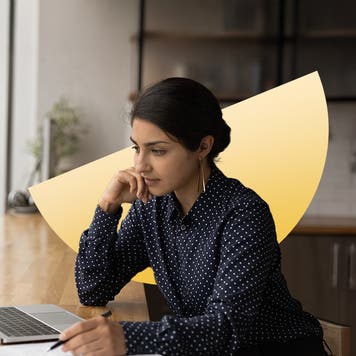South Asian woman working on her laptop