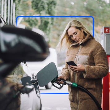 Woman paying at the gas pump