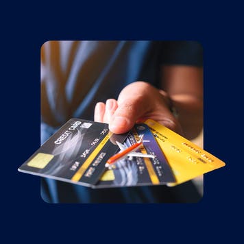Illustration portraying a hand holding several credit cards.