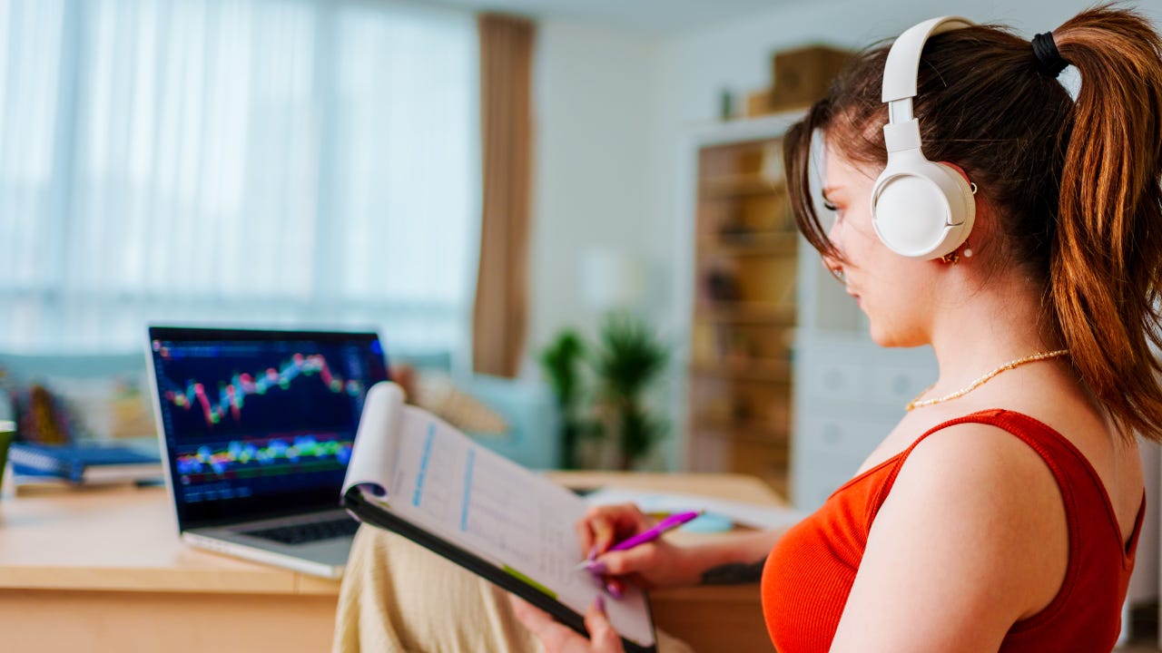 Young Businesswoman with Headphones checking Bitcoin or stock exchange