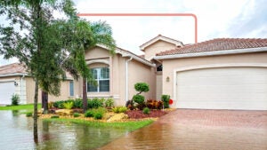 A house with water overflowing into the yard and driveway