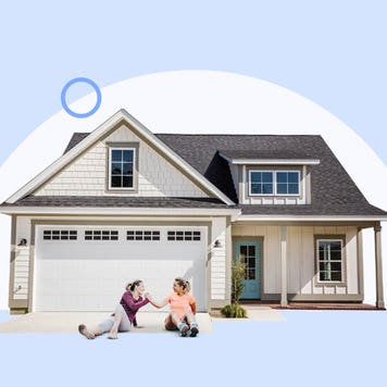 Two women sitting in front of an attached garage