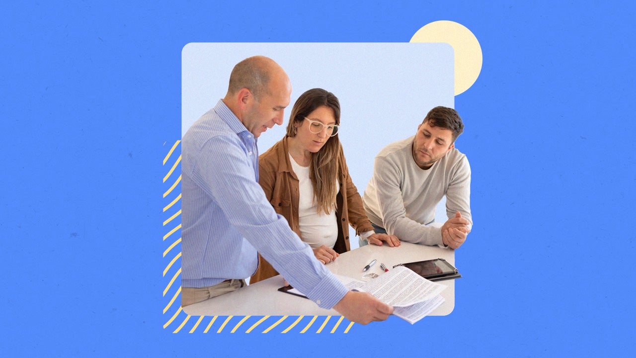 Three people looking over paperwork