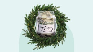 Evergreen wreath around a tip jar full of money