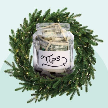 Evergreen wreath around a tip jar full of money