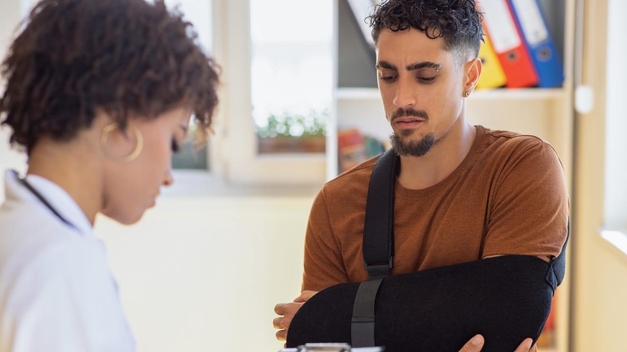 A person in a cast checking out of a hospital