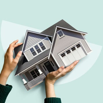 Image of a person holding onto a house