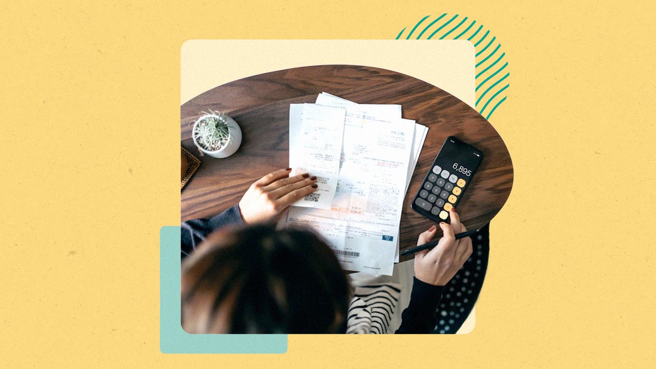 A person with papers in front of them, using a calculator