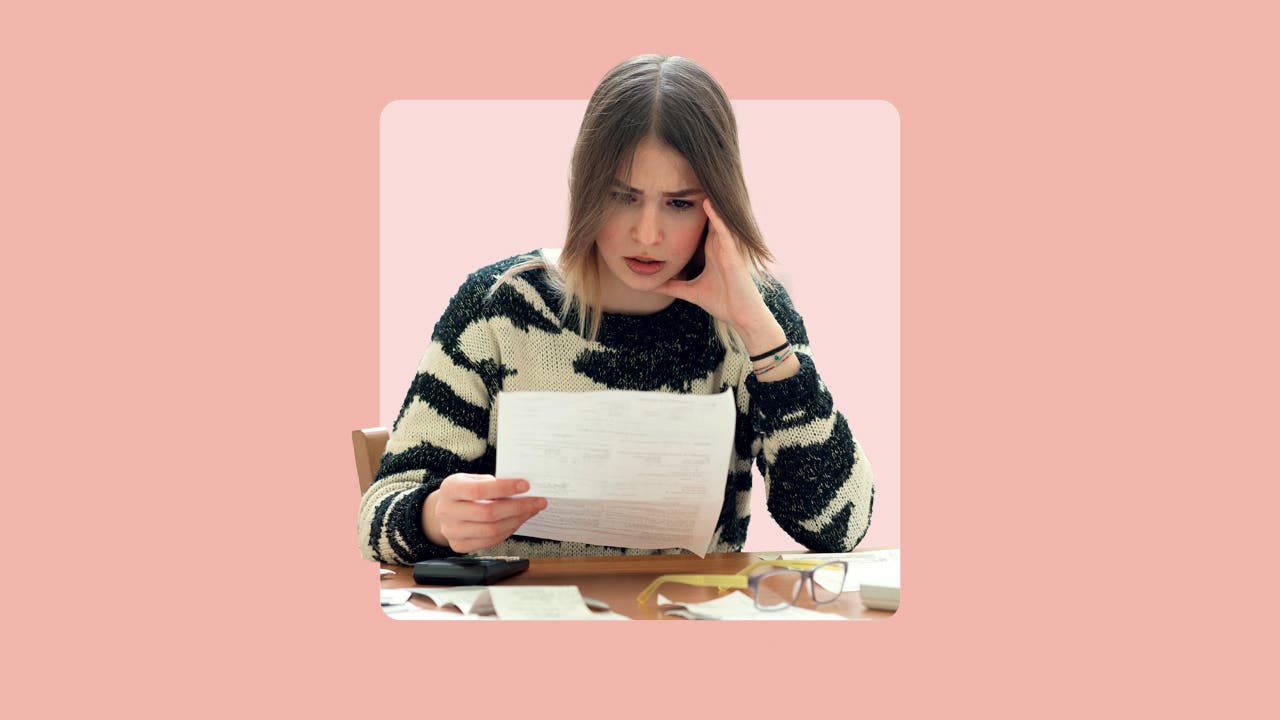A woman frowns at paperwork