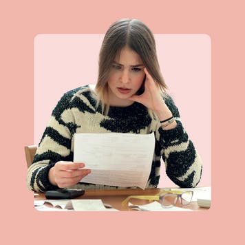 A woman frowns at paperwork