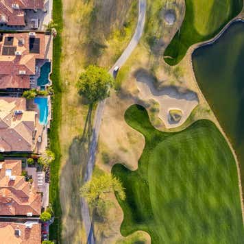 Line of houses next to a golf course.