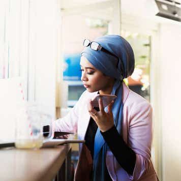 Young Muslim Woman Working in Cafe