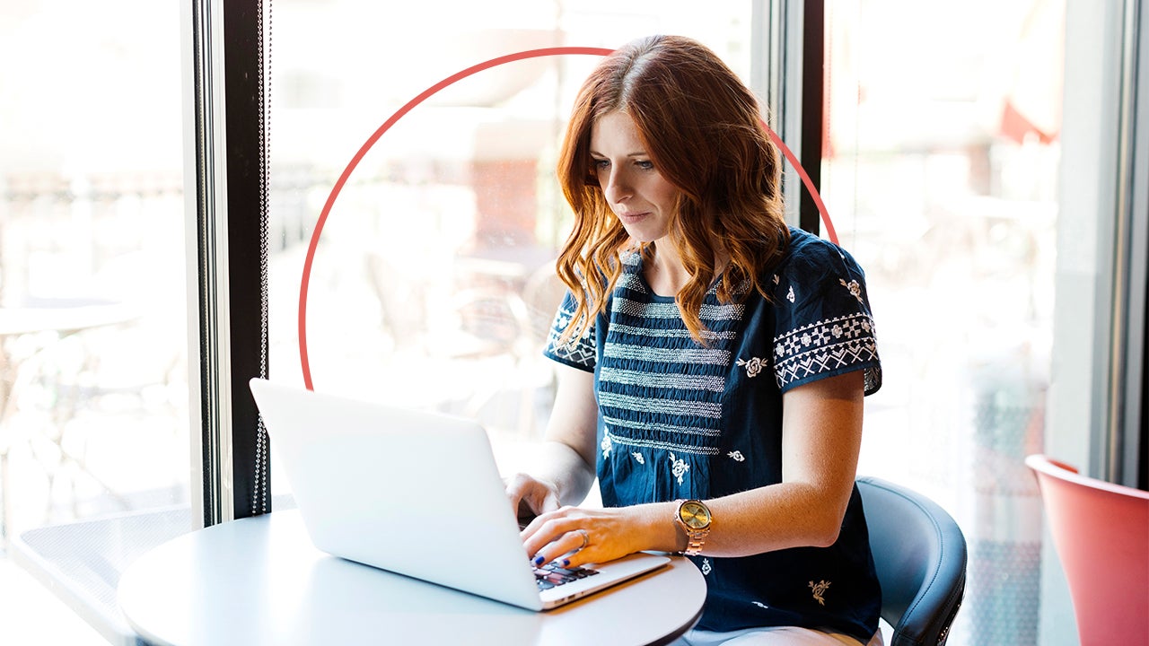 Woman typing on a laptop.