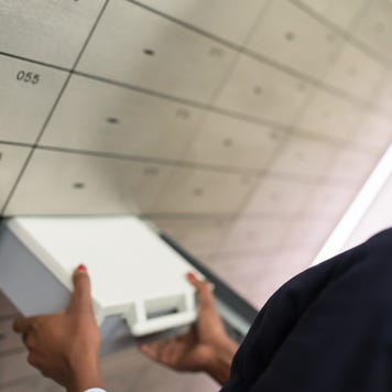 Person taking safety deposit box out