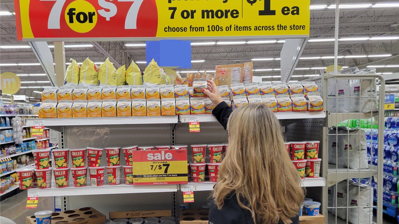 Someone shopping a sale rack at a grocery store
