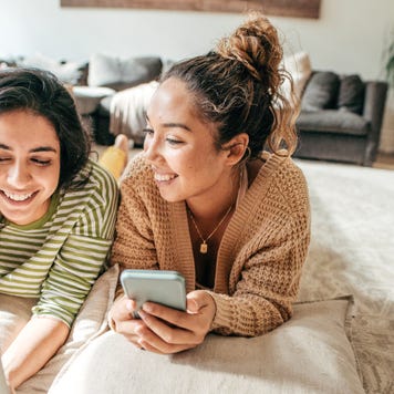 Two people looking at their mobile devices