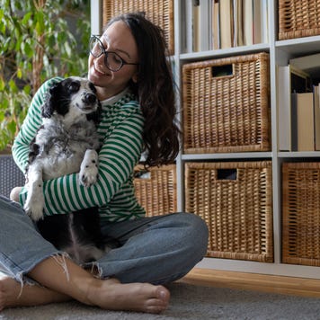 playing with dog on the floor in living room