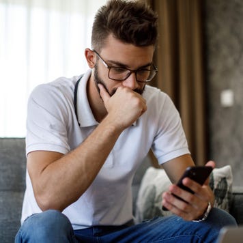 Young worried man working at home