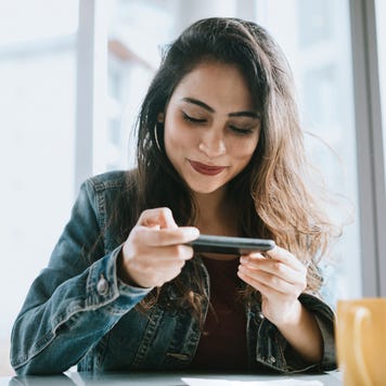 Young Woman Depositing Check With Smartphone
