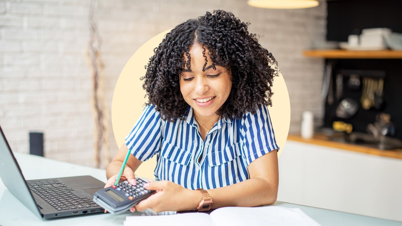 Woman looks at calculator