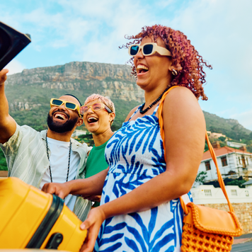 Three happy friends capture a cheerful moment with a selfie during their travel adventure