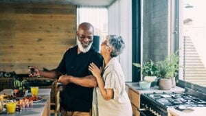 couple enjoying retirement, cooking up a healthy breakfast