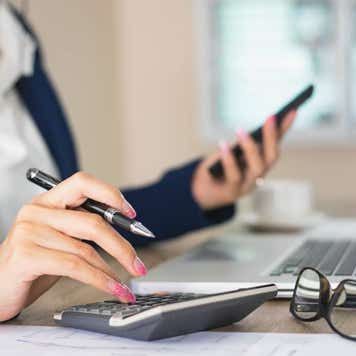 Close up of female accountant or banker making calculations