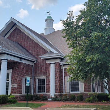A brick and mortar bank building on a sunny day