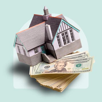 photo illustration of house balanced on stack of cash, light blue background