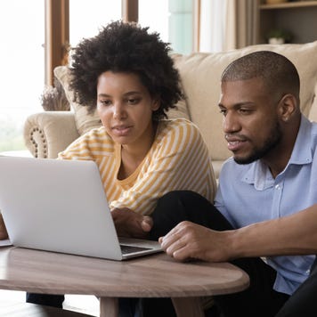 married couple looking at computer screen