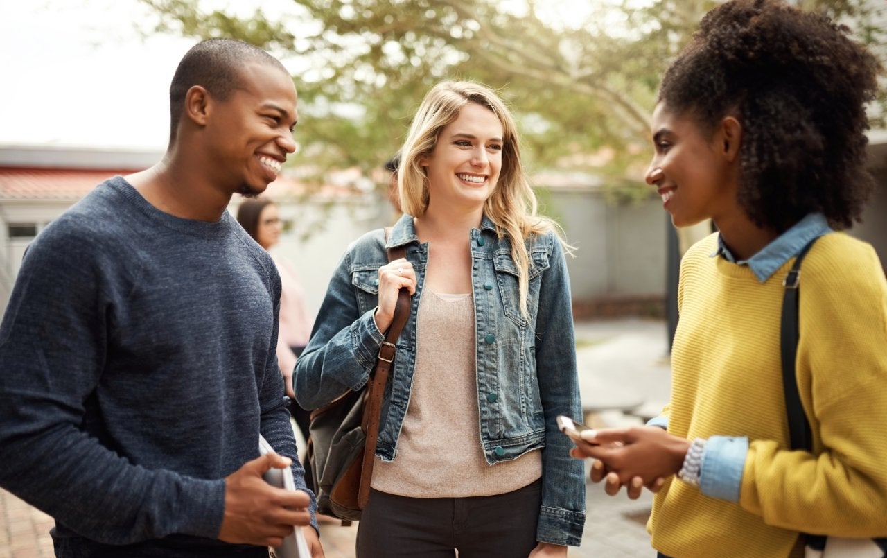 Friends chatting on a university campus.