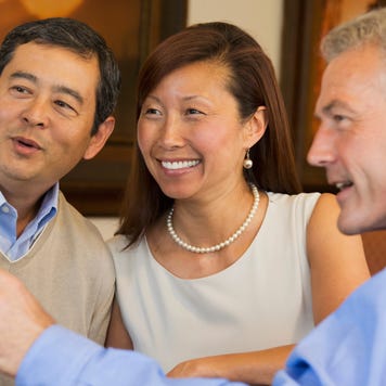 Couple looking at computer with their financial advisor