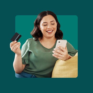 Woman paying a bill on her mobile phone with her bank card