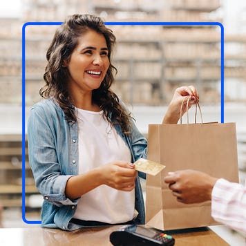 Person paying for goods with credit card.