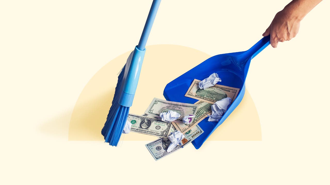 A blue broom and dustpan sweeping up cash.