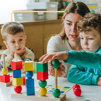 Kids playing with blocks at a school.