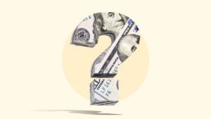 Big question mark on yellow backdrop wrapped up in a hundred dollar bill