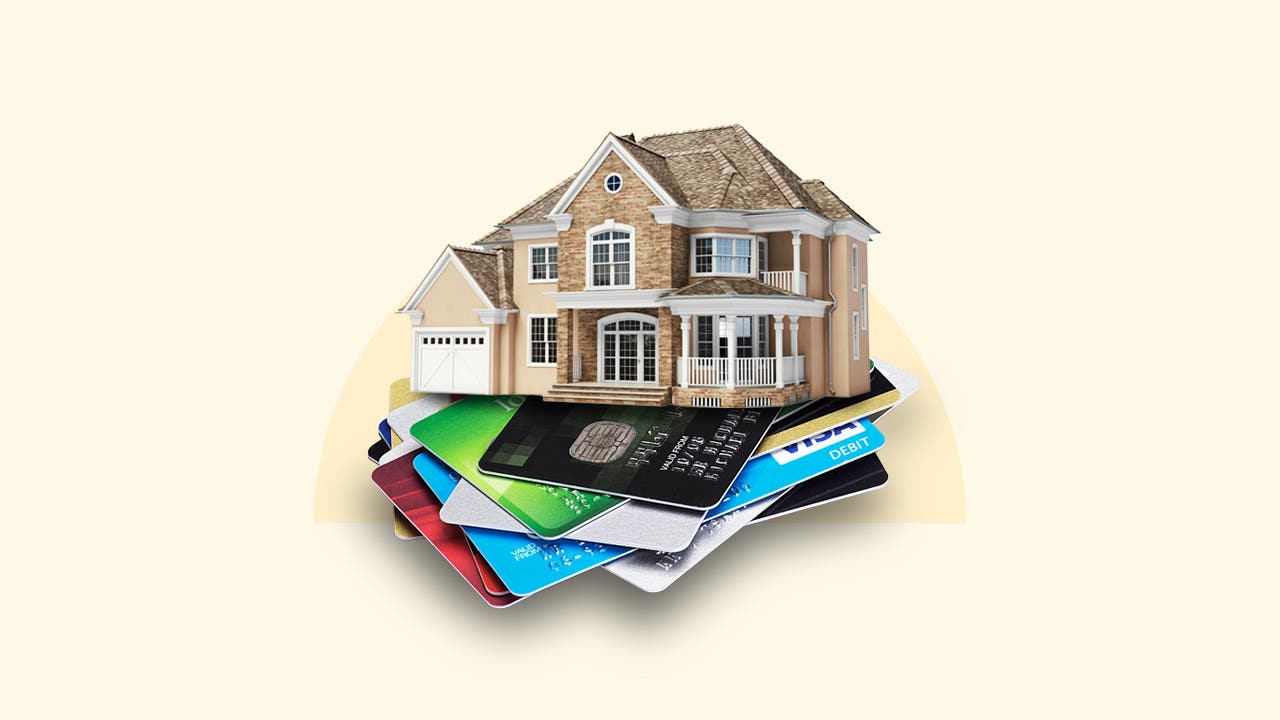 A house sitting atop a stack of credit cards