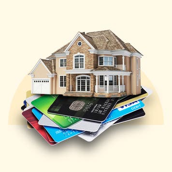 A house sitting atop a stack of credit cards