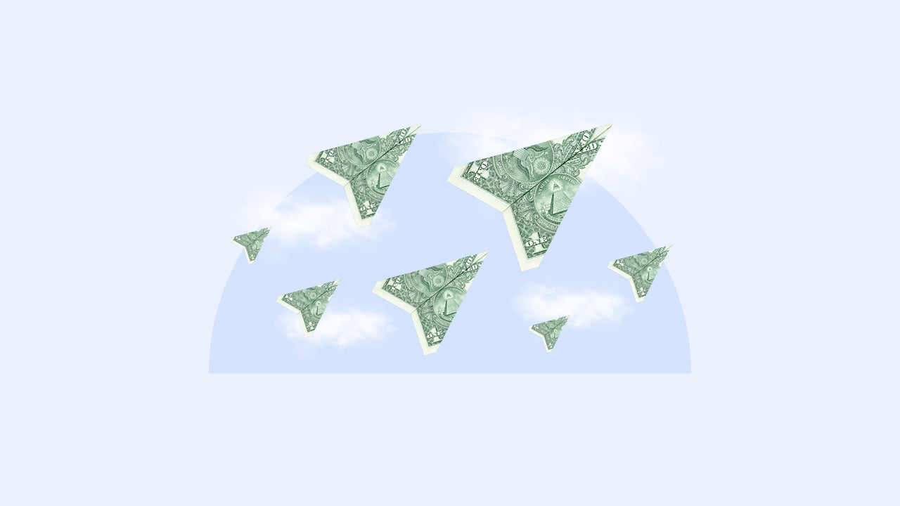 American dollar bills in the shape of paper airplanes on a background of clouds